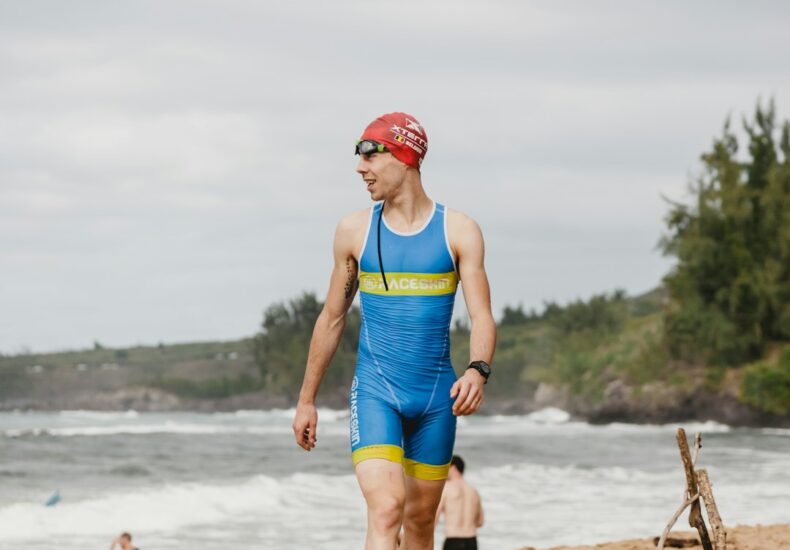 woman in blue tank top running on beach during daytime
