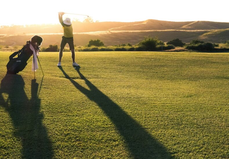 2 person walking on green grass field during daytime