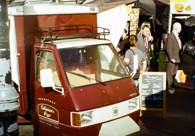 a small red van parked on the side of a street