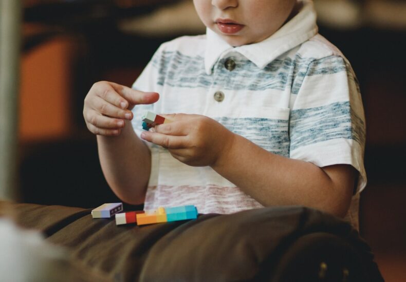 boy holding block toy