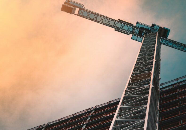low angle photography of gray tower crane