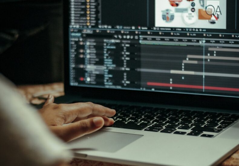 person using macbook pro on table