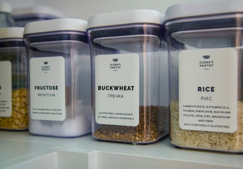 2 clear glass jars on white shelf