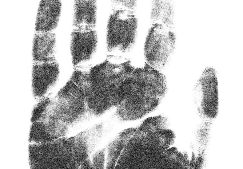 a black and white photo of a hand print