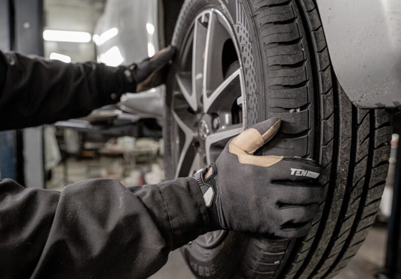 a man working on a tire in a garage
