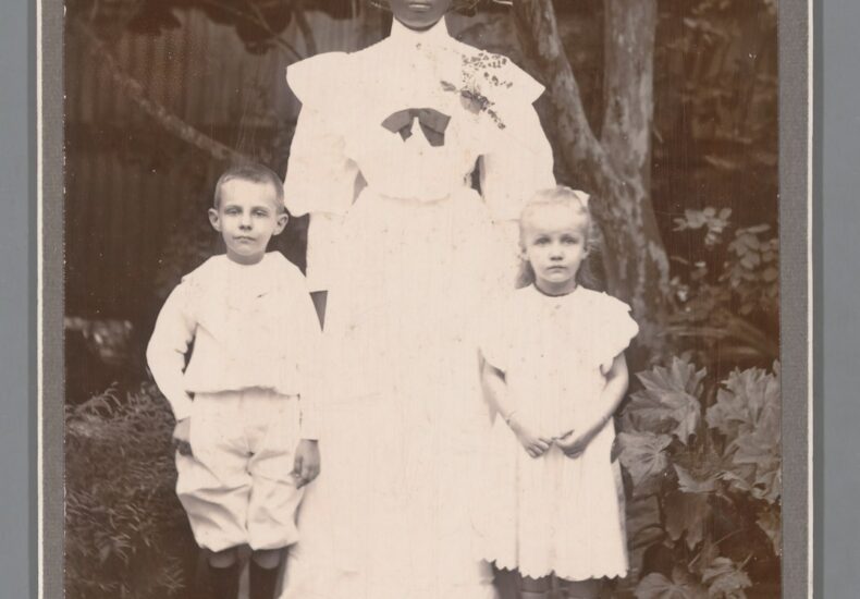 an old photo of a woman and two children