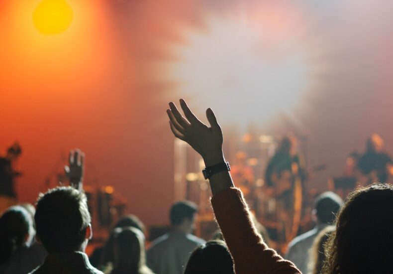 shallow focus photography of hand and people