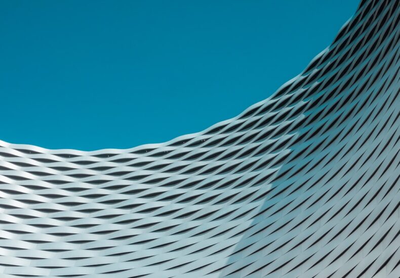 a building with wavy lines on it against a blue sky