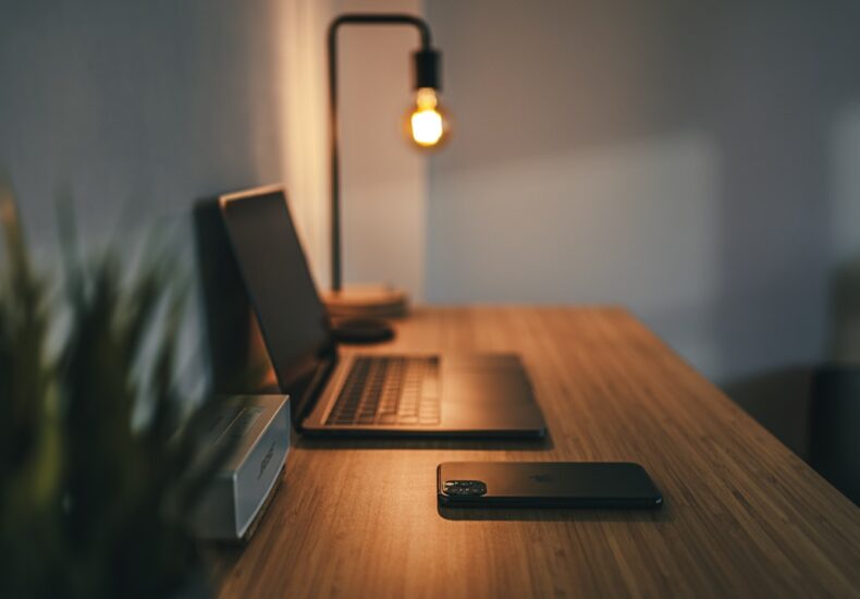 black laptop computer on brown wooden table