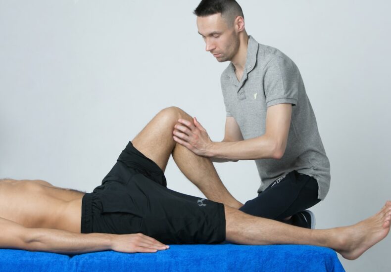 a man getting his leg examined by a doctor