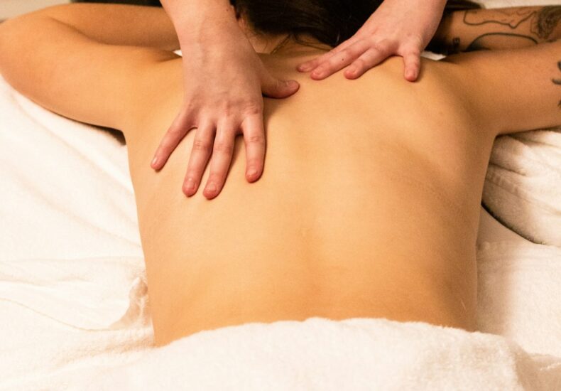 a woman getting a back massage at a spa