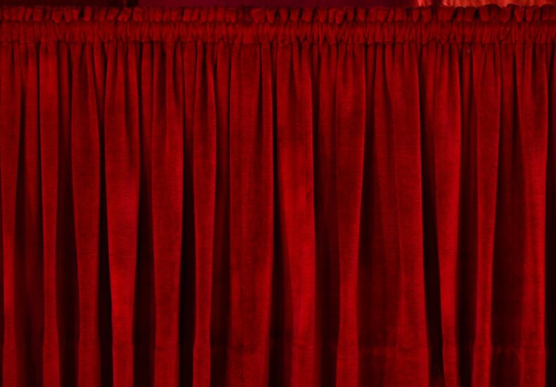 closeup photo of red rod pocket curtain