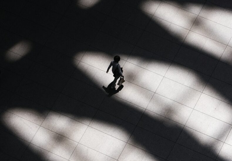 woman walking on white tiled flooring