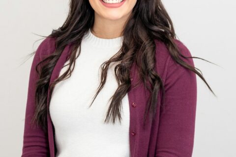 woman in red cardigan smiling