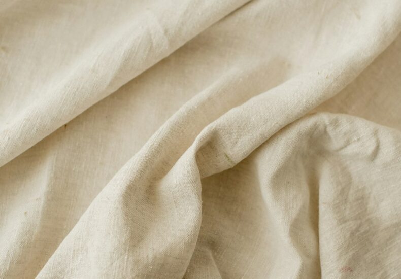 a close up of a bed with a white sheet