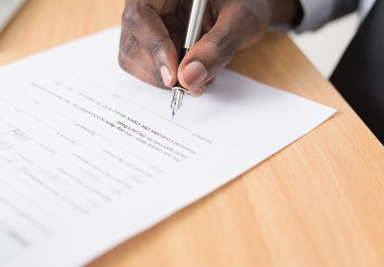 person writing on white paper