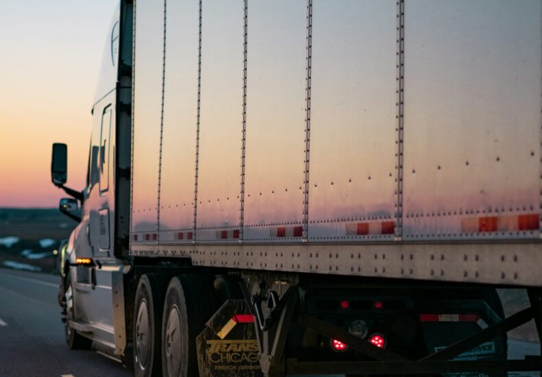 white freight truck on road during daytime