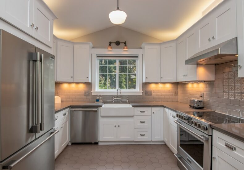 white wooden kitchen cabinet with white pendant lamp