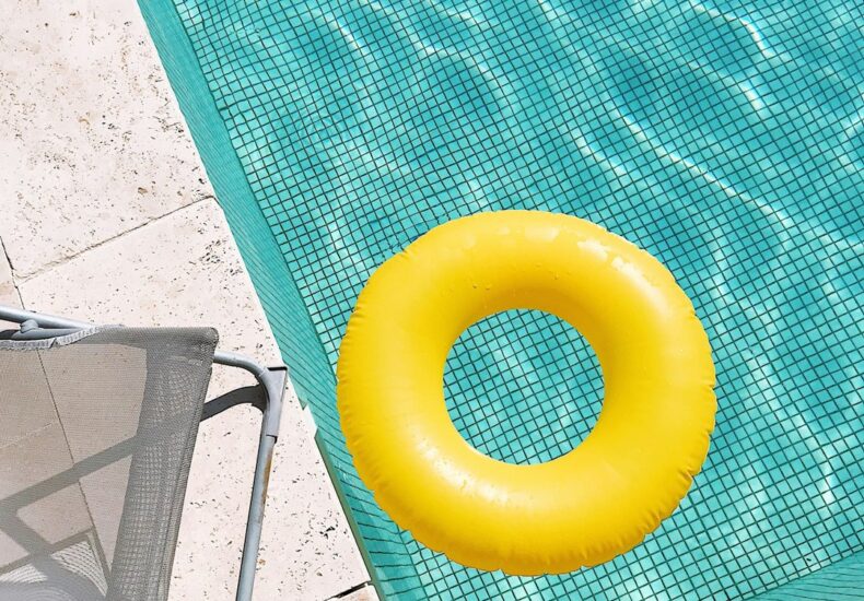 yellow plastic round toy on green table