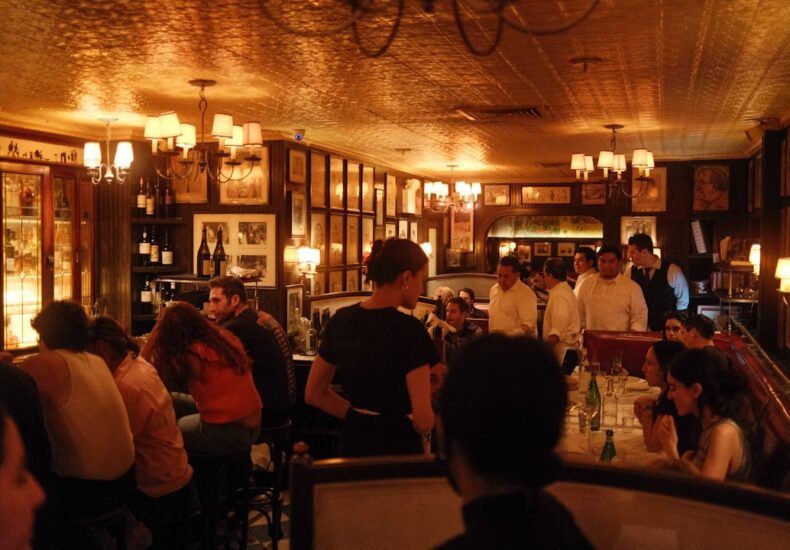 a group of people sitting at tables in a restaurant
