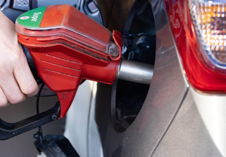 a person pumping gas into a car at a gas station