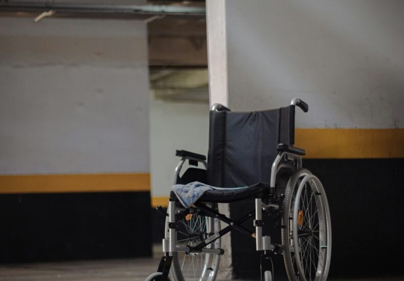 black and gray wheelchair on blue floor