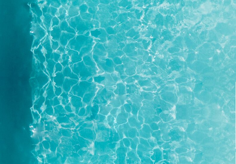 person about to dive on swimming pool