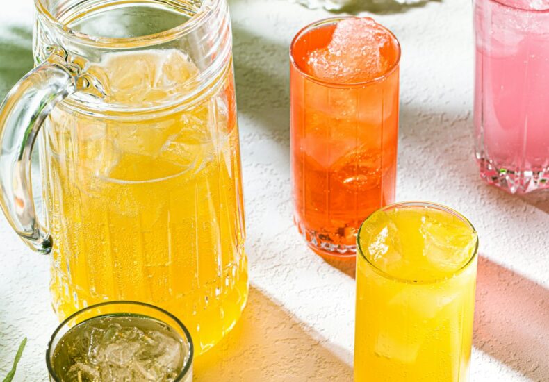 a table topped with glasses and pitchers filled with drinks