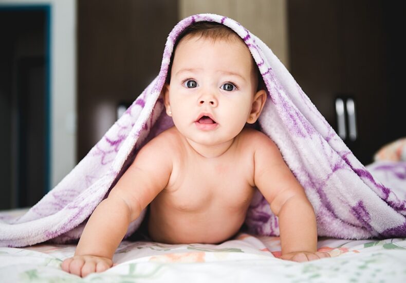 baby under purple blanket