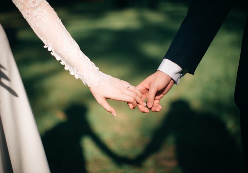 man and woman holding hands focus photo