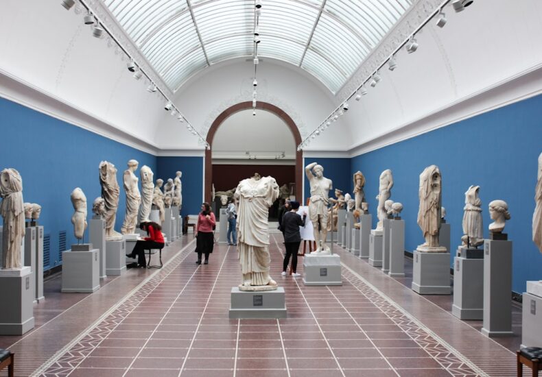 people watching statue in gallery room