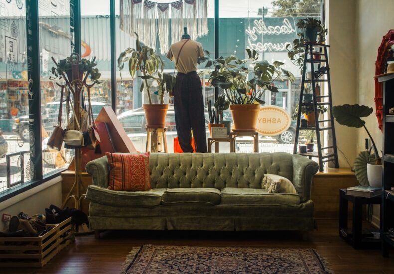 a living room filled with furniture and lots of windows