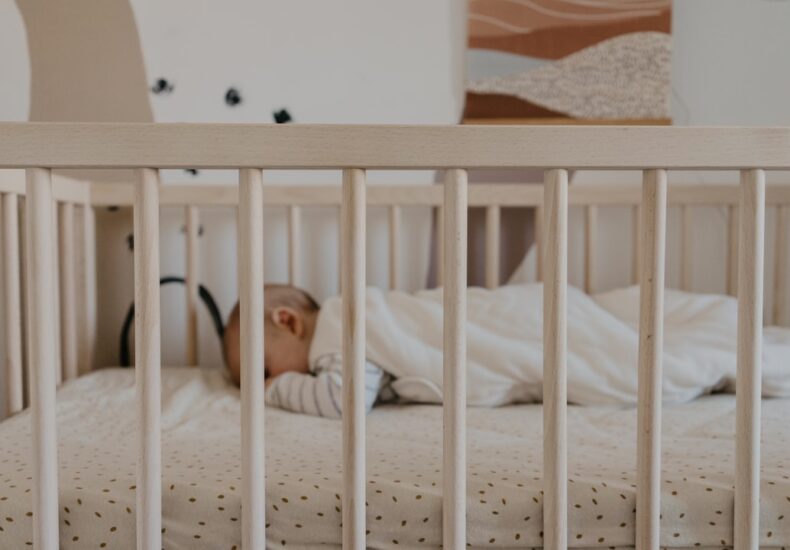 a person sleeping in a crib