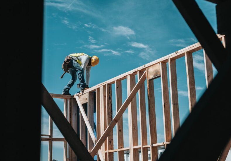 construction worker in hard hat on building frame