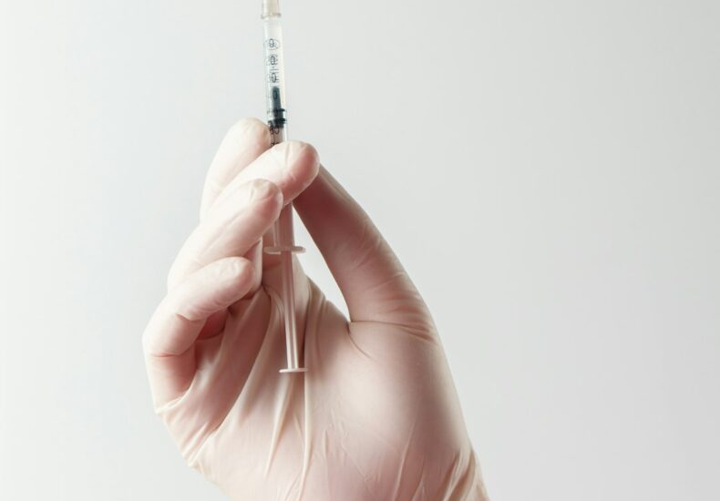 a hand holding a needle