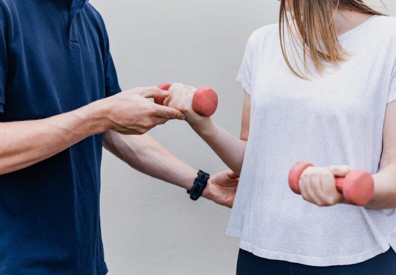a man and a woman holding dumbs in their hands