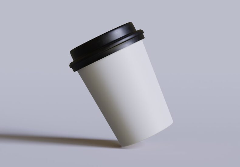 a white coffee cup with a black lid
