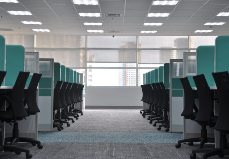 empty black rolling chairs at cubicles