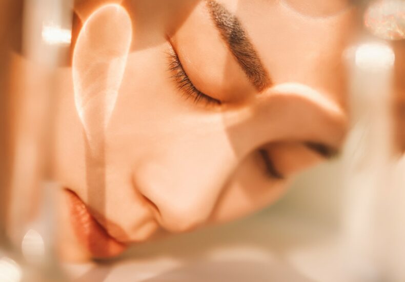 woman portrait with closed eyes through glass