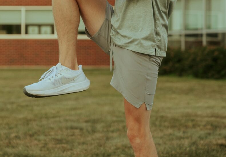 a man sitting on a skateboard on a sidewalk