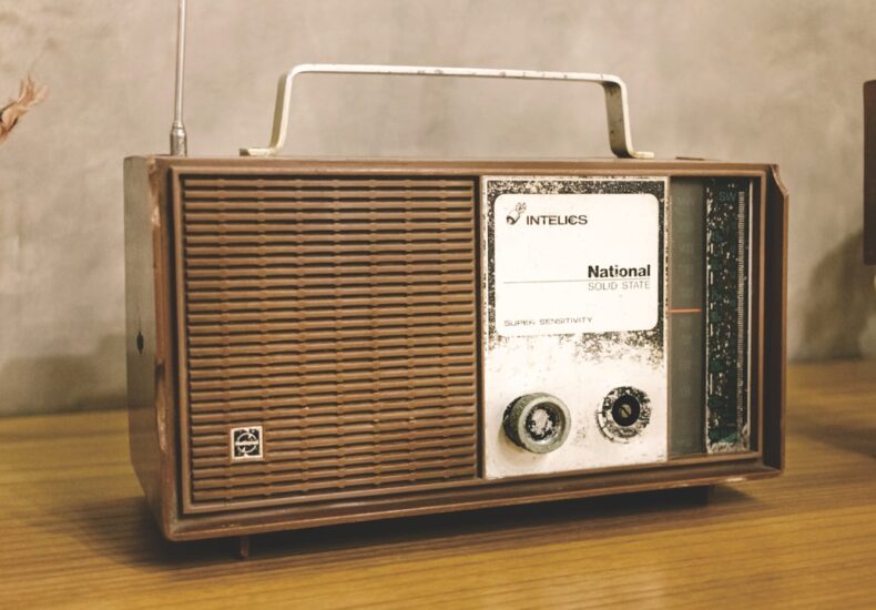 A radio sitting on top of a wooden table