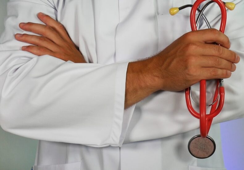 doctor holding red stethoscope