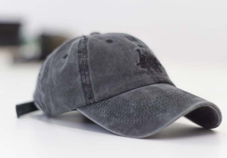 gray baseball cap on white surface