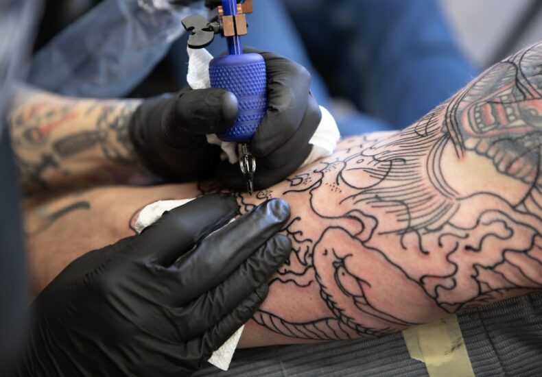 person with tattoo on right arm