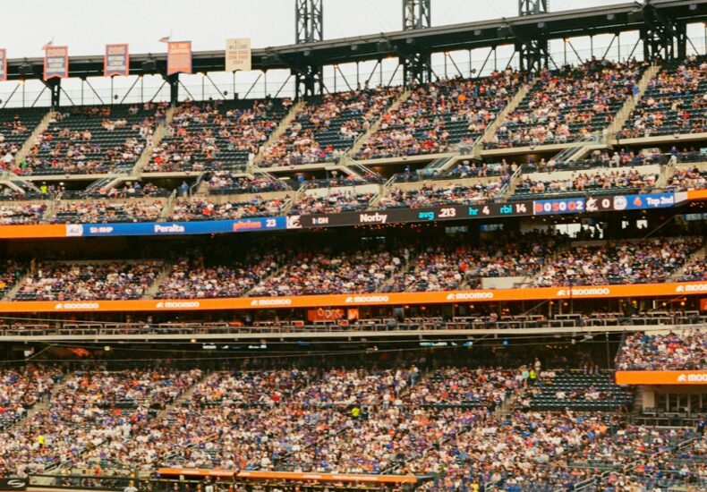 A baseball game in a crowded stadium under bright lights