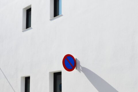 A white building with no parking sign