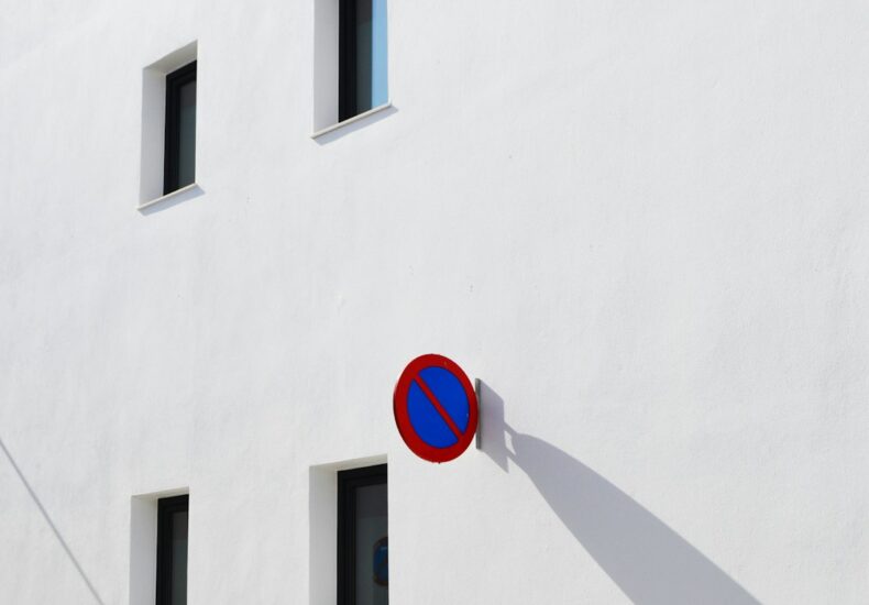 A white building with no parking sign