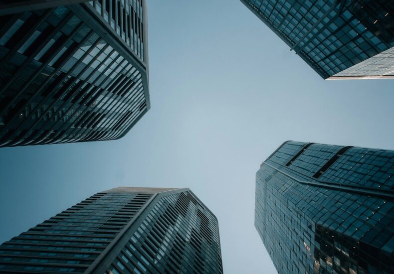 Modern skyscrapers reaching towards a clear blue sky