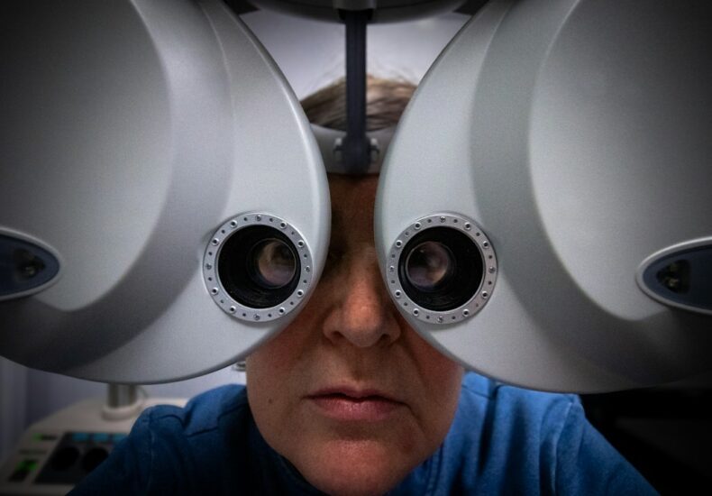 Patient looking through an eye examination machine
