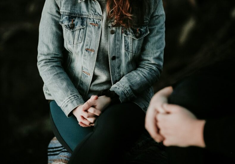 woman in denim jacket sitting